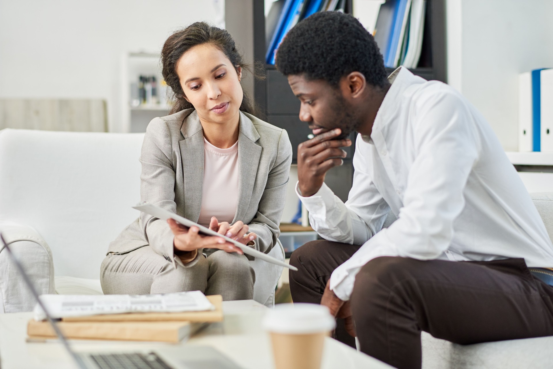Concentrated black man reading contract at meeting